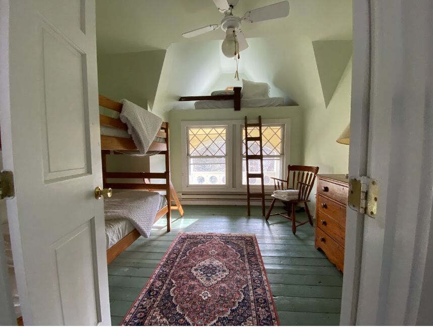 The Green Room with twin bunk beds under the eaves