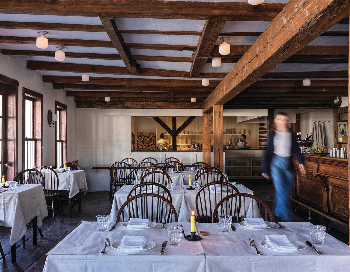 Candlelit dining room with wood beams at Stissing House