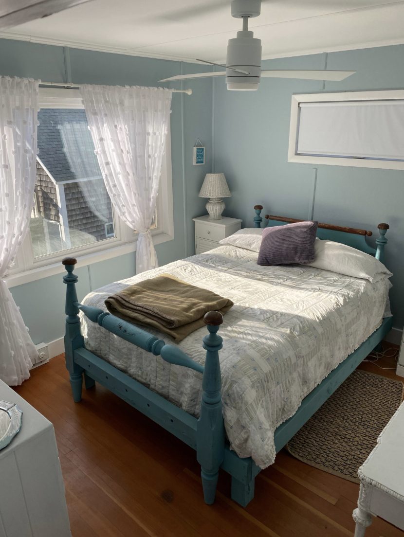 Bedroom with a blue painted queen bed