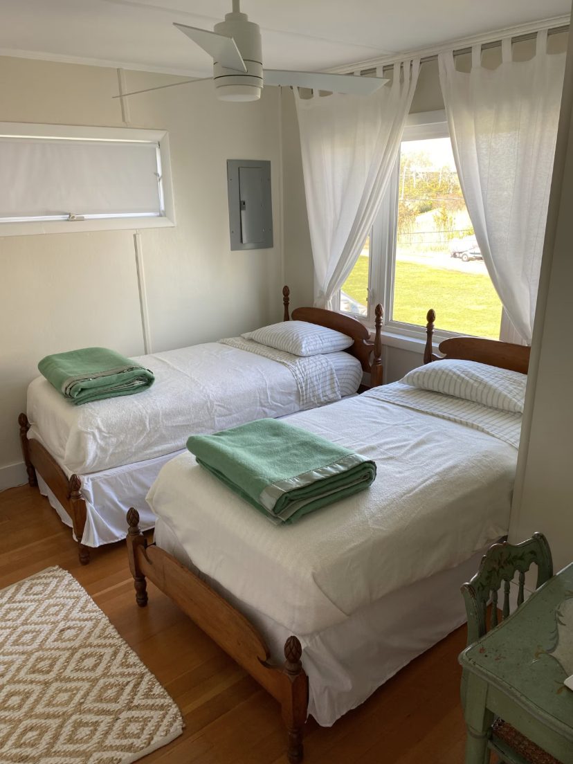 Bedroom with two wooden twin beds