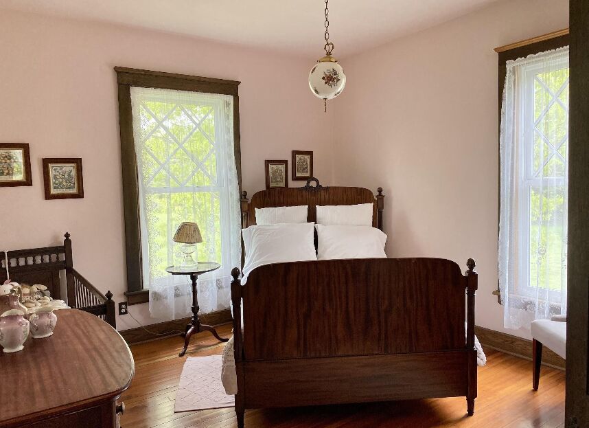The Pink Room with a rosewood bed and pale pink walls