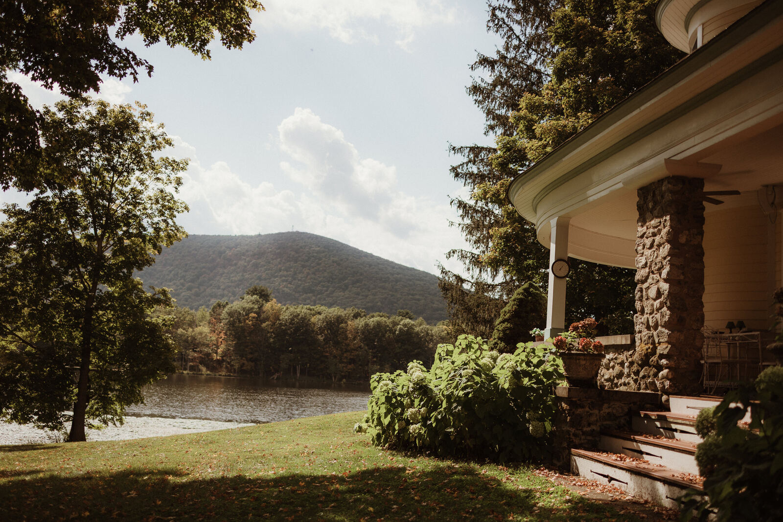 View from the porch steps across the lawn to the lake and mountain