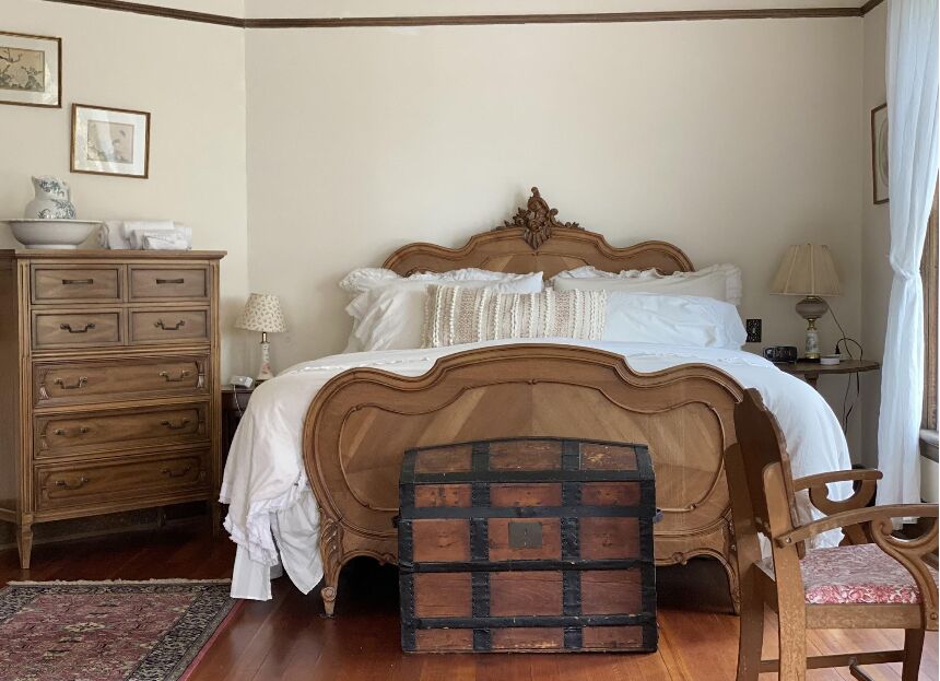 Carved antique walnut bed in the primary bedroom