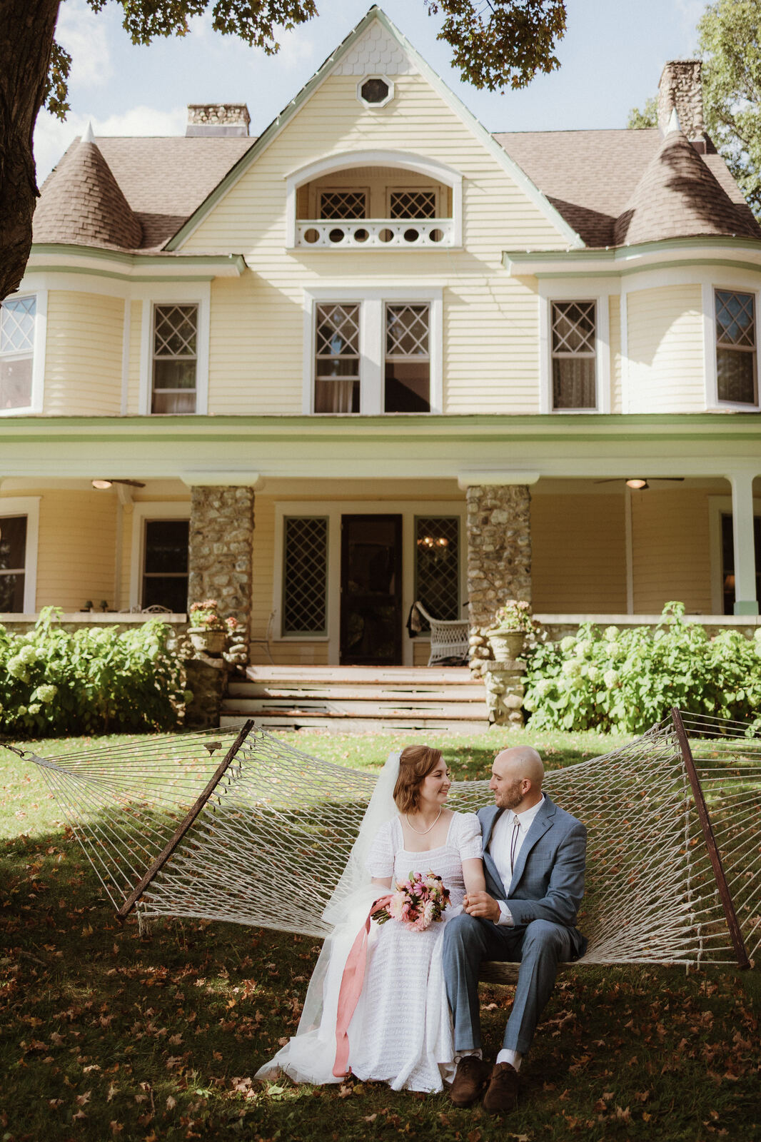 A couple on the hammock in front of the house